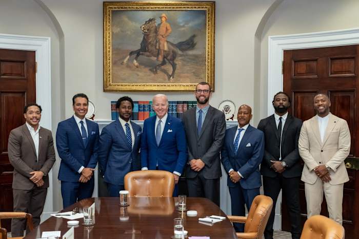 From left: Jordan Meachum, College Football Players Association representative; Kevin Negandhi, ESPN SportsCenter anchor; Desmond Howard, 1991 Heisman Trophy winner and host of ESPN College Gameday; U.S. president Joe Biden; Former Stanford and Colts quarterback Andrew Luck; ESPN college football analyst Rod Gilmore; Keith Marshall, former Georgia running back and Co-Founder/CEO of the Players' Lounge; Former LSU and Steelers safety and current ESPN analyst Ryan Clark